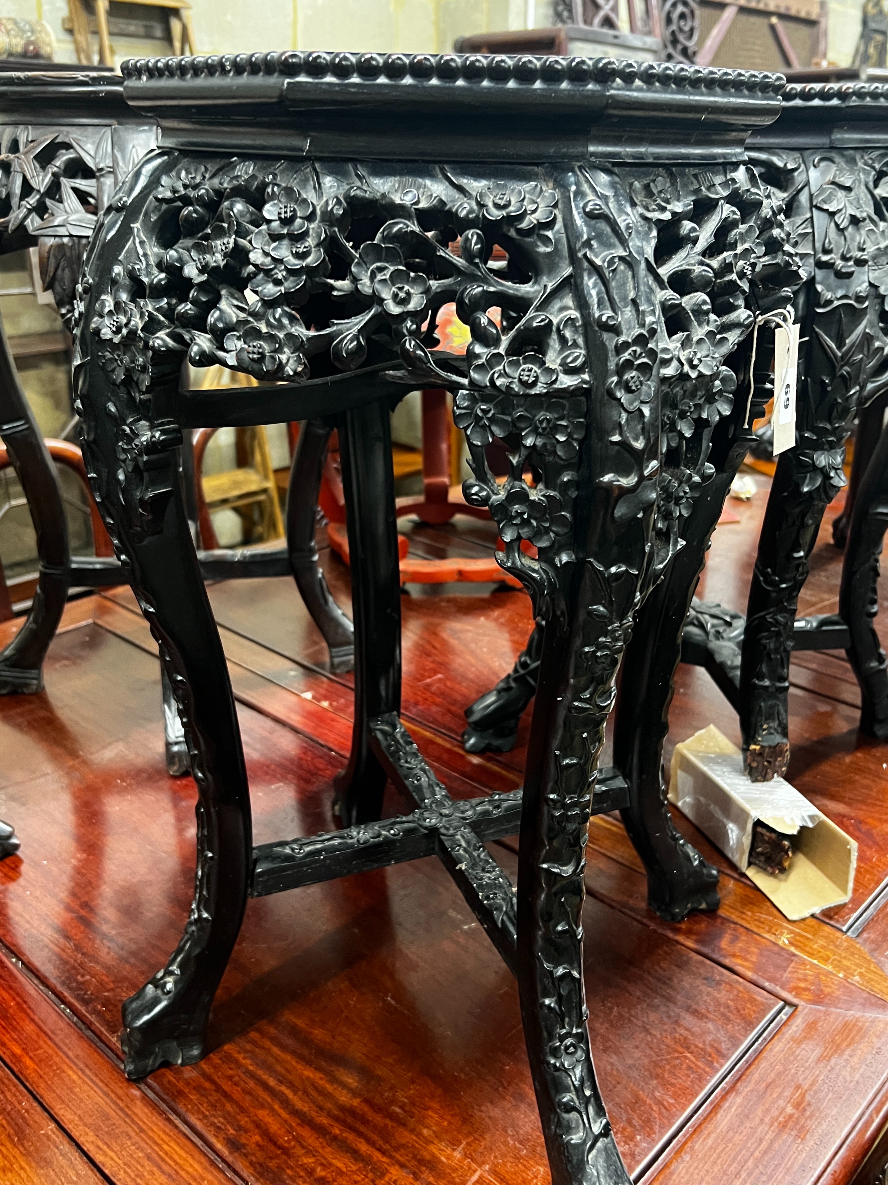 A near pair of Chinese marble top octagonal carved hongmu vase stands, width 40cm, height 62cm